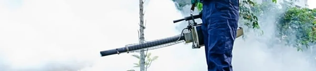Pest control technician fogging an outdoor area for insect control in Newark, NJ